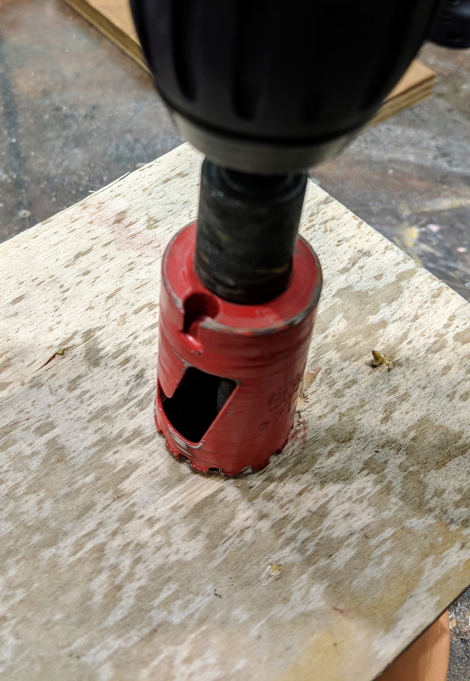 A simple jig for cutting a larger hole in the bottom of a clay pot used for fusing/casting glass