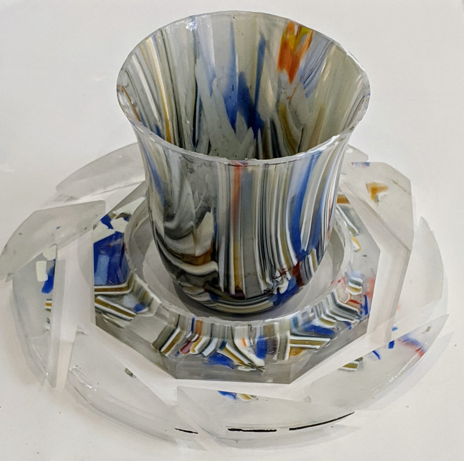 Removing the rim off a drop ring glass vessel using a wet tile saw.