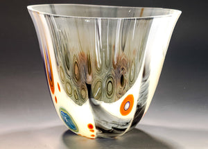 Glass vase with multicolored patterns on a dark background